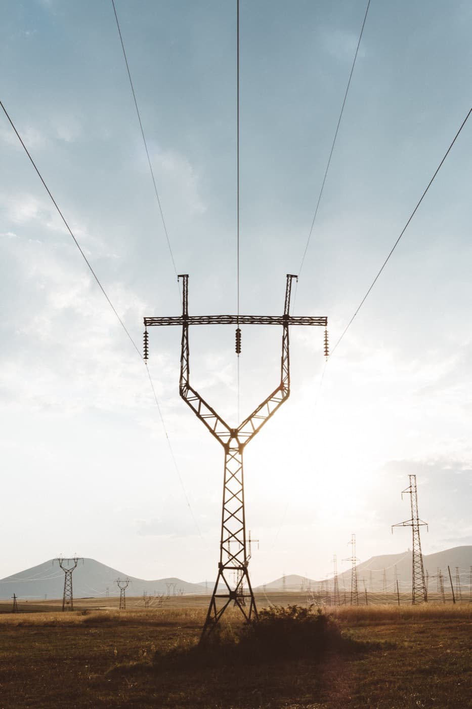 High-voltage transmission tower at dusk