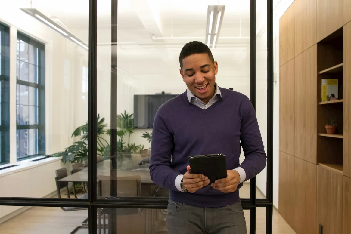 Knowledge worker reviewing an AI tool on a tablet in a modern office